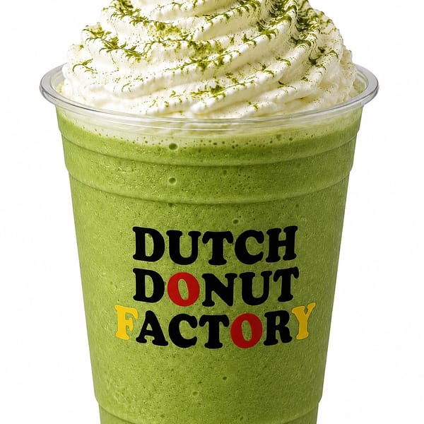 Green matcha frappe with whipped cream and matcha powder in a Dutch Donut Factory cup.